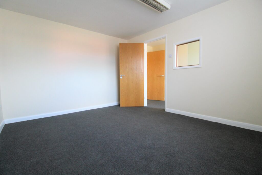 Empty office space with an open door